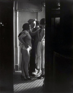 Brassai - Chez Suzy - three women around a man - 1932