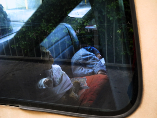 Josiane Keller - puppet riding in back seat of a car