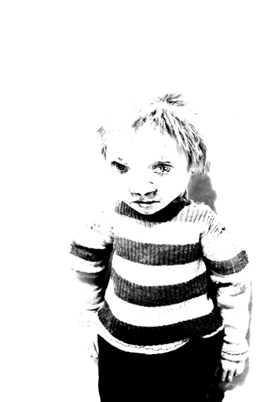 Josiane Keller - little boy standing by a wall - close-up