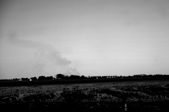 Edie Weisslechner - smoke coming from a farm in the distance